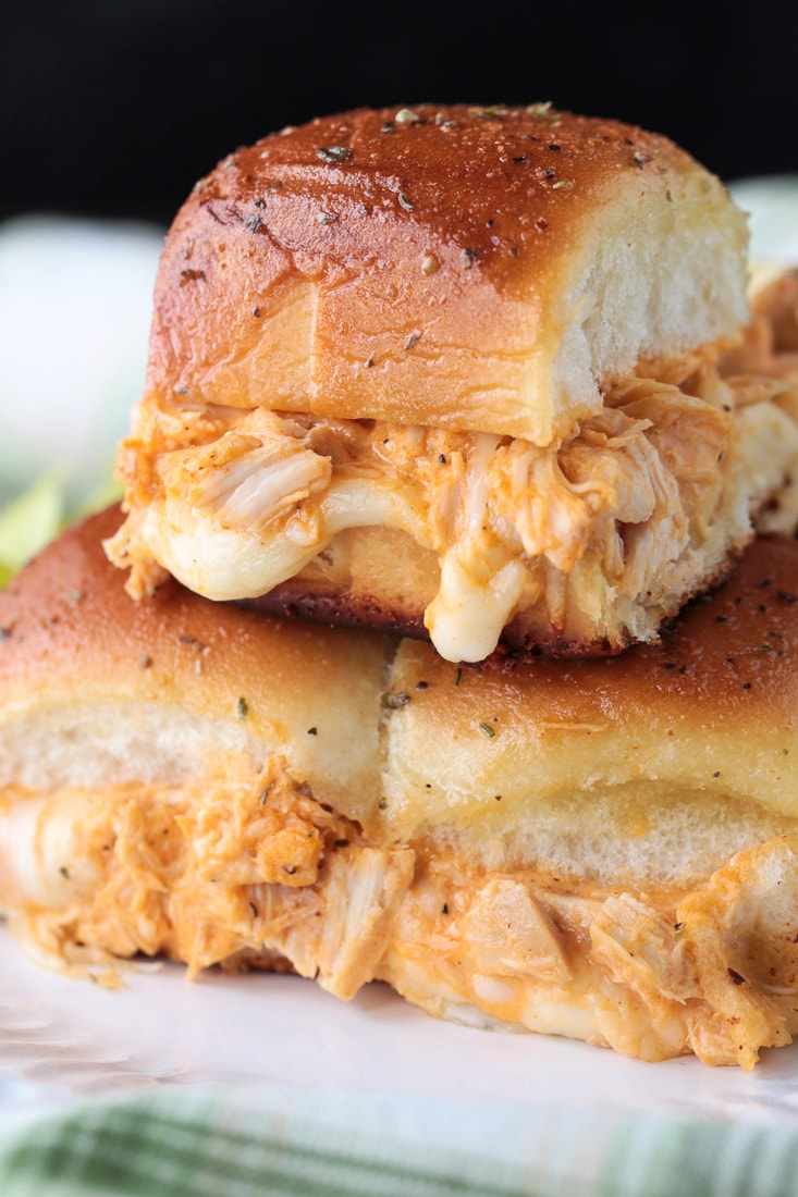 buffalo chicken sliders stacked on white plate