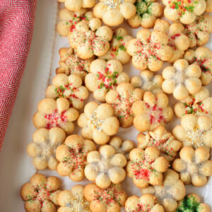 spritz cookies on white platter with napkin