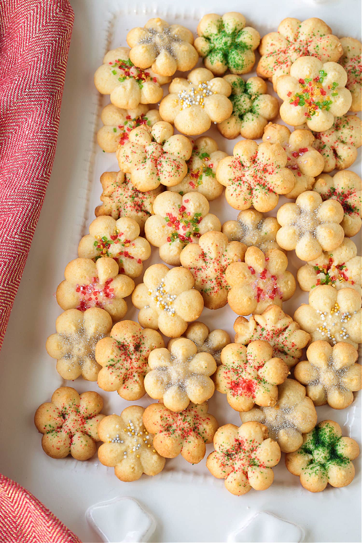 spritz cookies on white platter with napkin