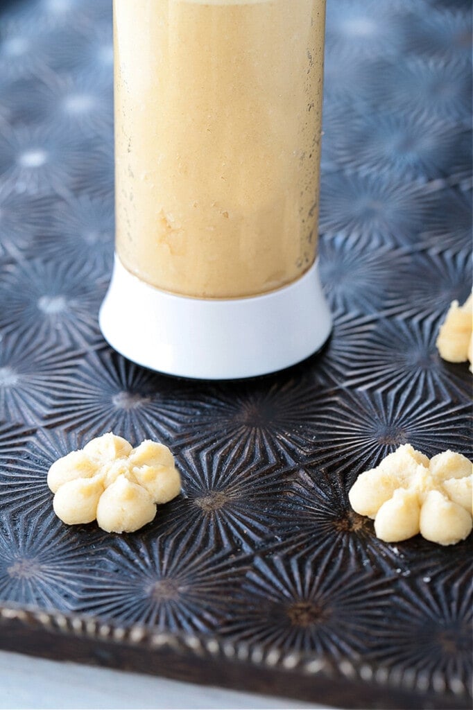 cookie press on baking sheet