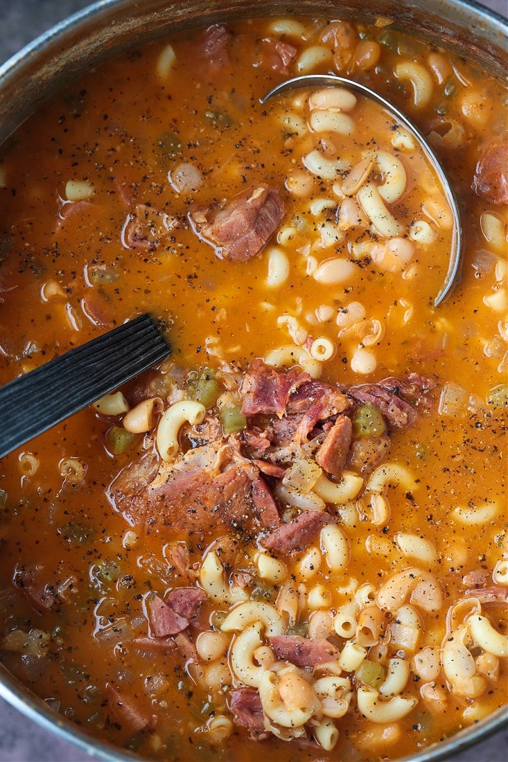 pot of ham and noodle soup with ladle