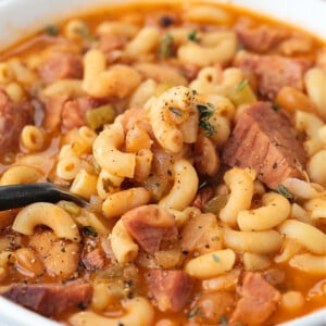 ham and macaroni soup in a bowl with spoon