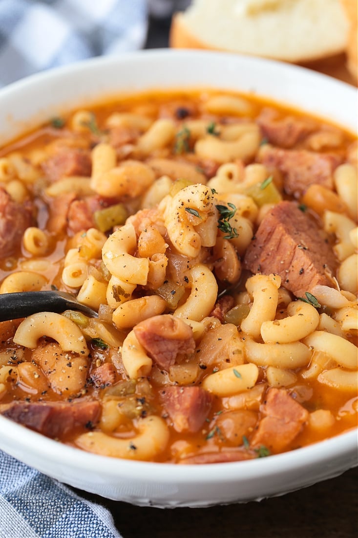 ham and macaroni soup in a bowl with spoon