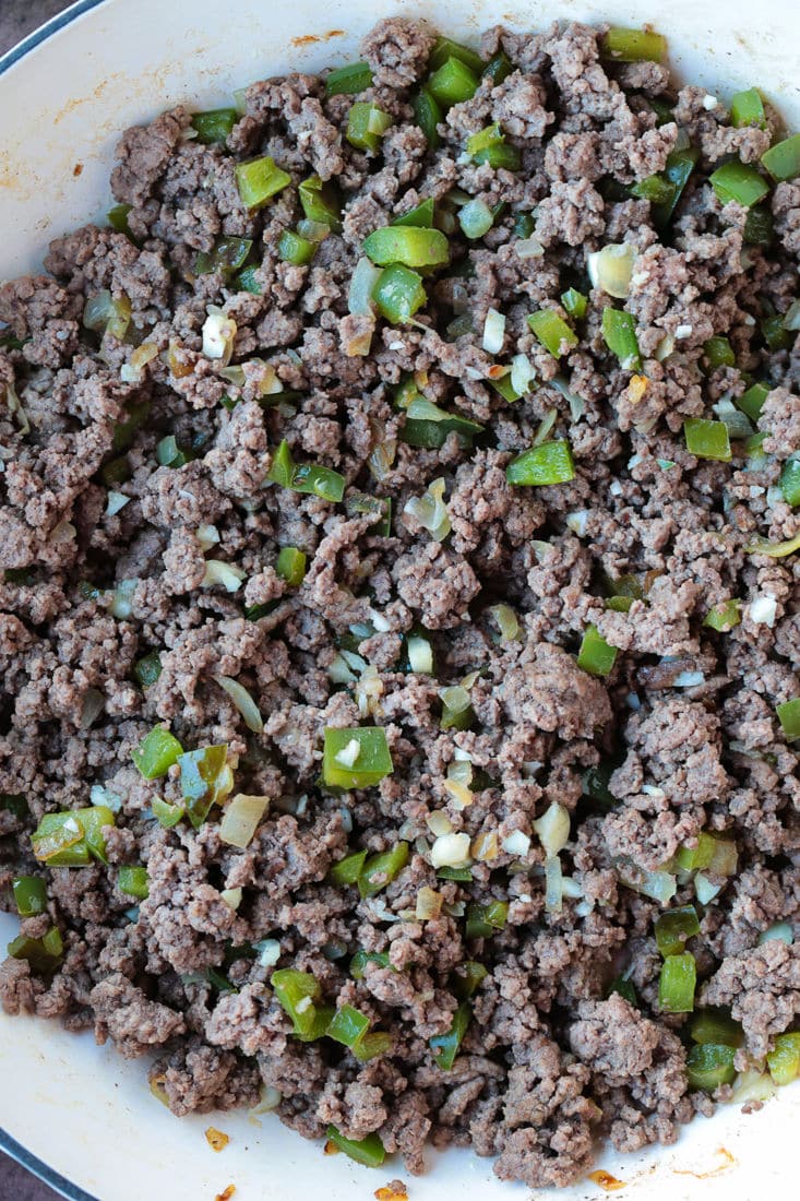 ground beef, onions and peppers in a skillet