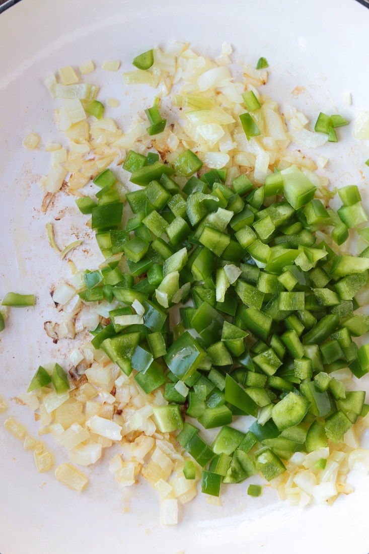 green bell peppers and onions in a skillet