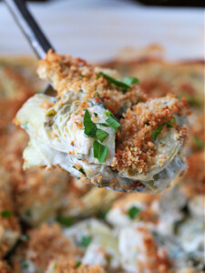 stuffed artichoke casserole on a spoon