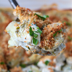 stuffed artichoke casserole on a spoon