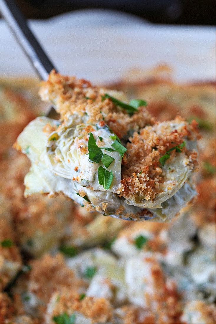 stuffed artichoke casserole on a spoon