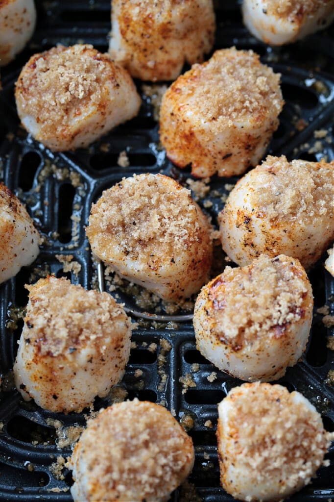 These Air Fryer Scallops are perfectly cooked and are melt in your mouth tender. An easy seafood dinner recipe for any occasion! panko topping on scallops in air fryer