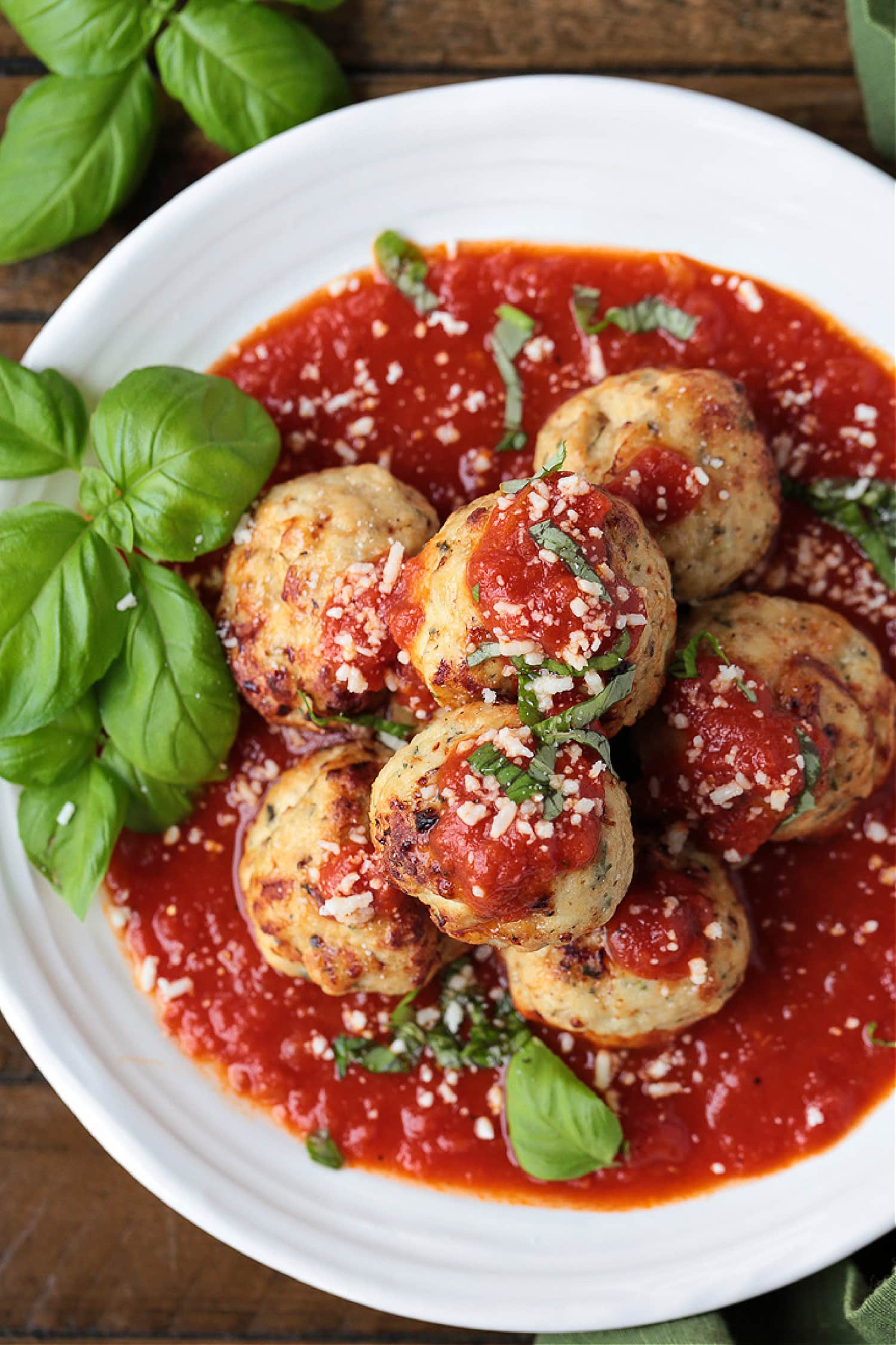 turkey meatballs stacked on plate with sauce