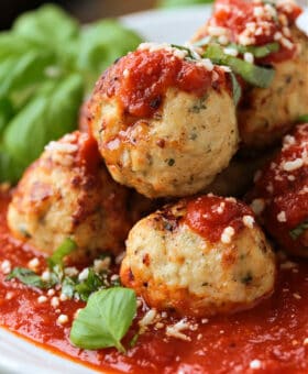 turkey meatballs stacked on a plate with sauce
