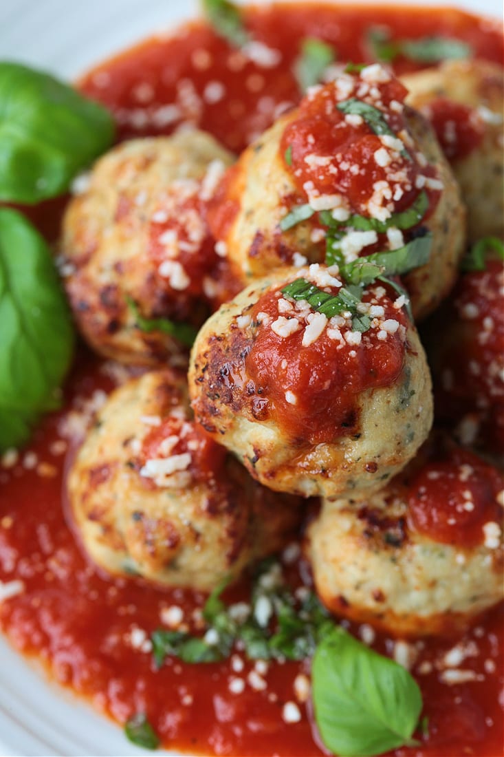 turkey meatballs stacked on a plate with sauce