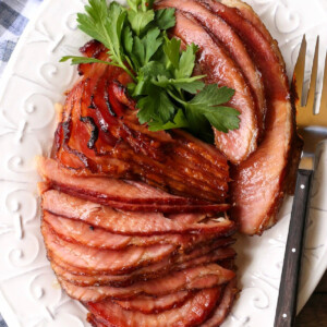 slices of ham on platter with serving fork