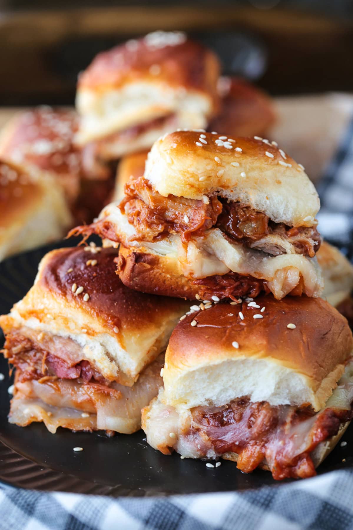 pulled pork sliders stacked on a plate