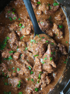 slow cooker beef tips with black spoon