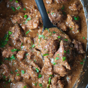 slow cooker beef tips with black spoon