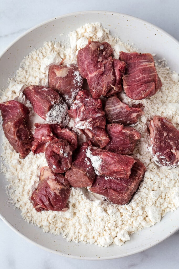 beef tips on a plate with flour