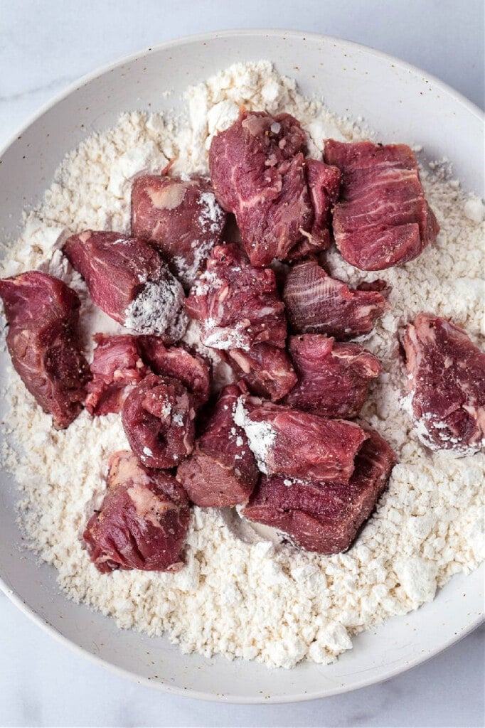 beef tips on a plate of flour