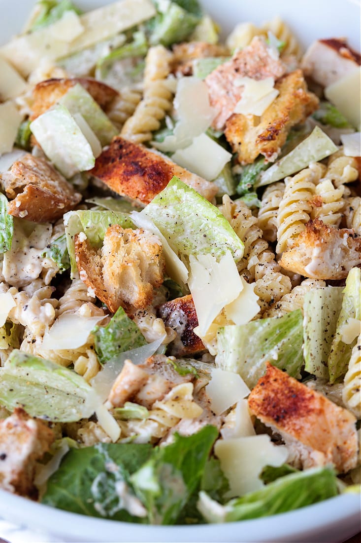 This Chicken Caesar Pasta Salad is bursting with flavor! Pasta tossed with lettuce and crunchy croutons, and our homemade Caesar dressing! pasta salad with lettuce, chicken, croutons and cheese