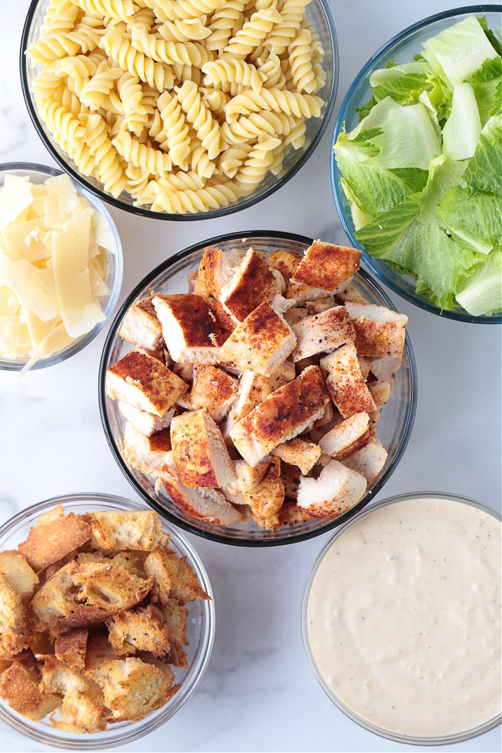 This Chicken Caesar Pasta Salad is bursting with flavor! Pasta tossed with lettuce and crunchy croutons, and our homemade Caesar dressing! ingredients for making chicken caesar pasta salad