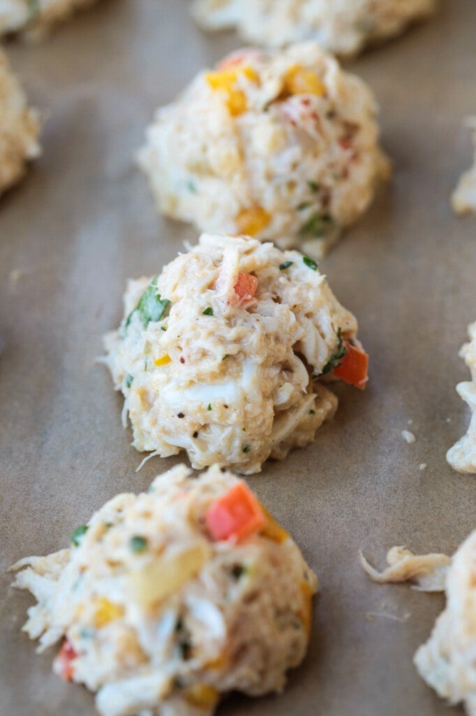 crab balls on a baking sheet before cooking