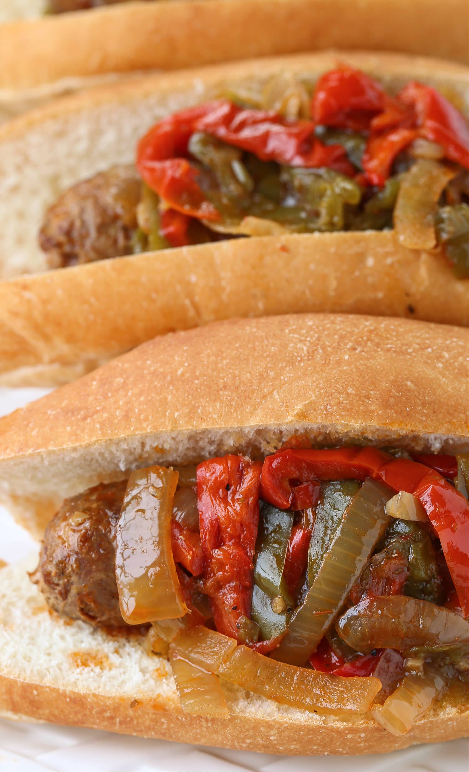 sausage and pepper sandwiches close up on platter