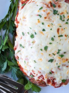meatloaf topped with sauce and cheese on platter