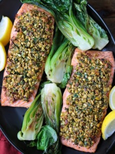 black platter with pistachio crusted salmon and bok choy