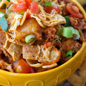 ground beef and cheese casserole with fritos in yellow bowl