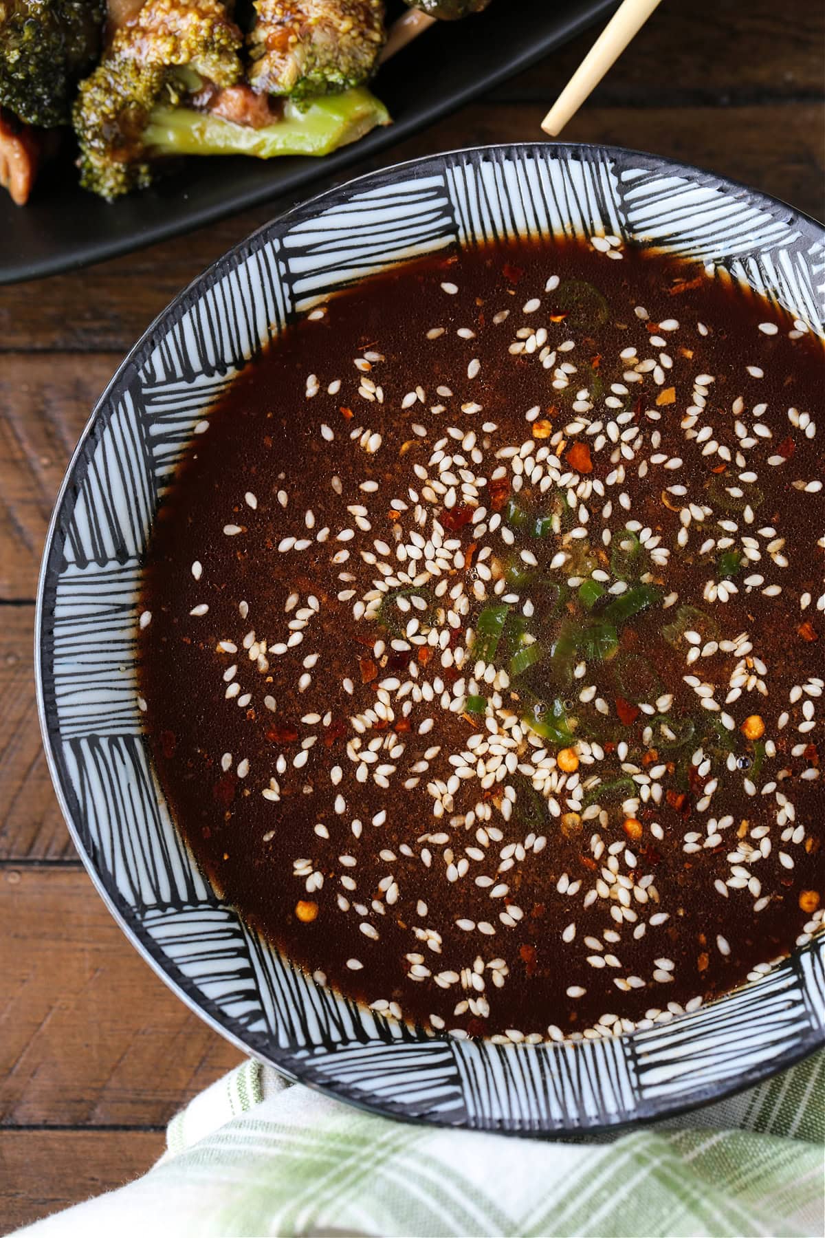 Our Homemade Stir Fry Sauce is ready in seconds! Use this bright and flavorful sauce in your favorite stir fry recipes and so much more. stir fry sauce in bowl topped with sesame seeds