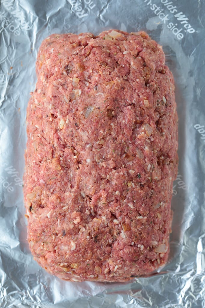 formed meatloaf on a baking sheet with foil