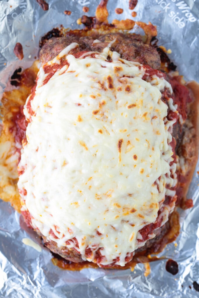 meatloaf recipe topped with sauce and mozzarella cheese