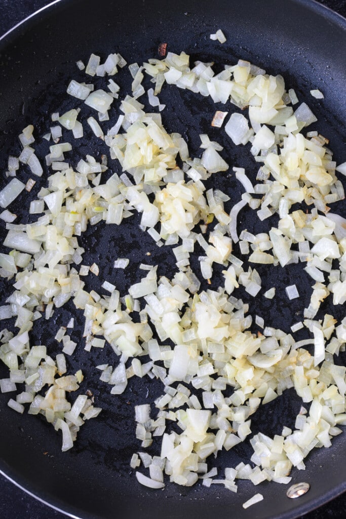 diced onions in a skillet