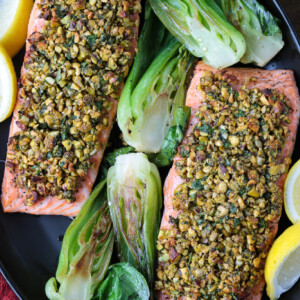 black platter with pistachio crusted salmon and bok choy