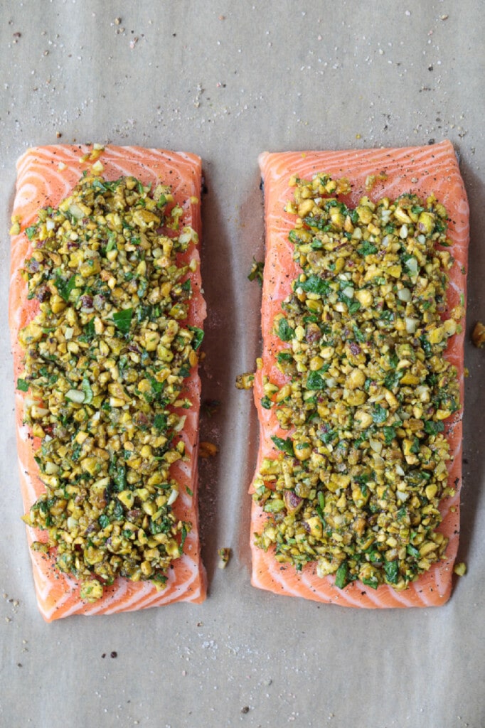 This Pistachio Crusted Salmon recipe is ready to serve in just 20 minutes! Perfectly cooked salmon with a pistachio, honey and garlic crust. pistachio crusted salmon filets before baking