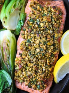 black platter with pistachio crusted salmon and bok choy