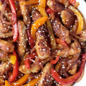 pork stir fry in a bowl topped with sesame seeds