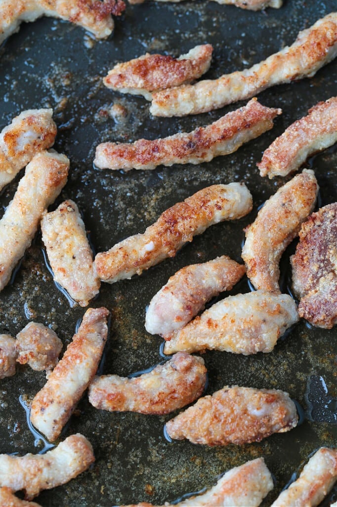 crispy seared pork strips in a wok