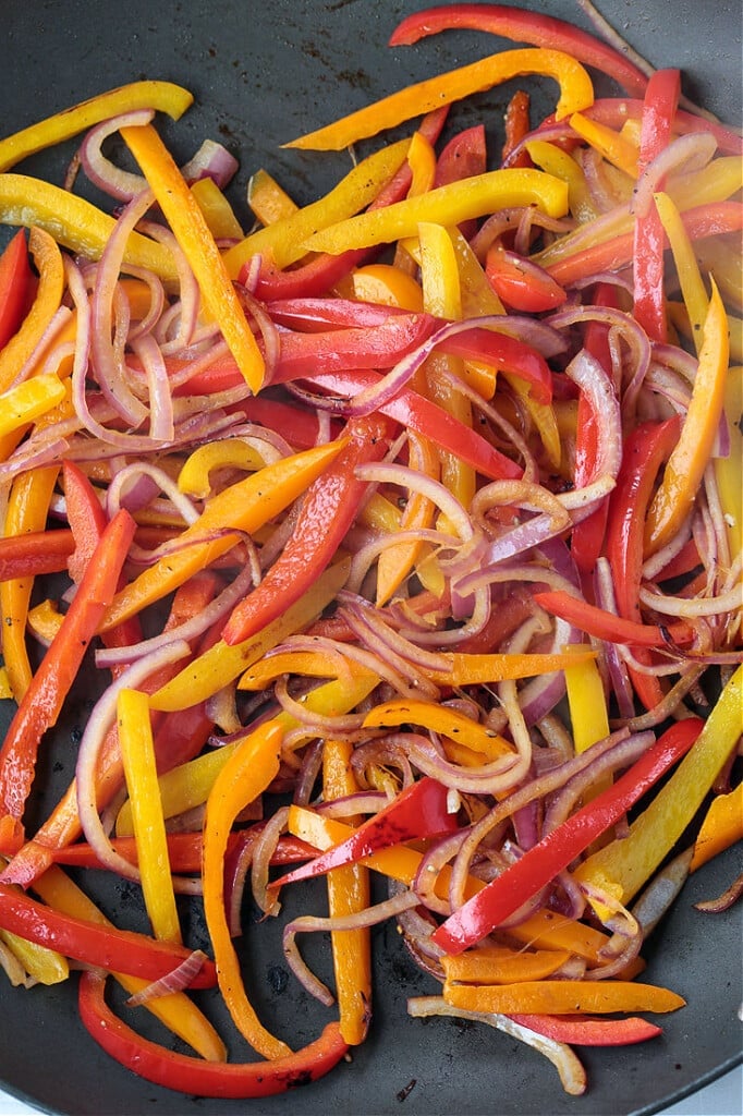 peppers and onions cooked in a wok