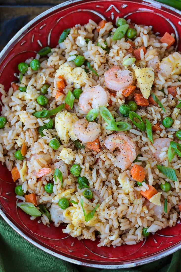 shrimp fried rice in a red bowl from the top