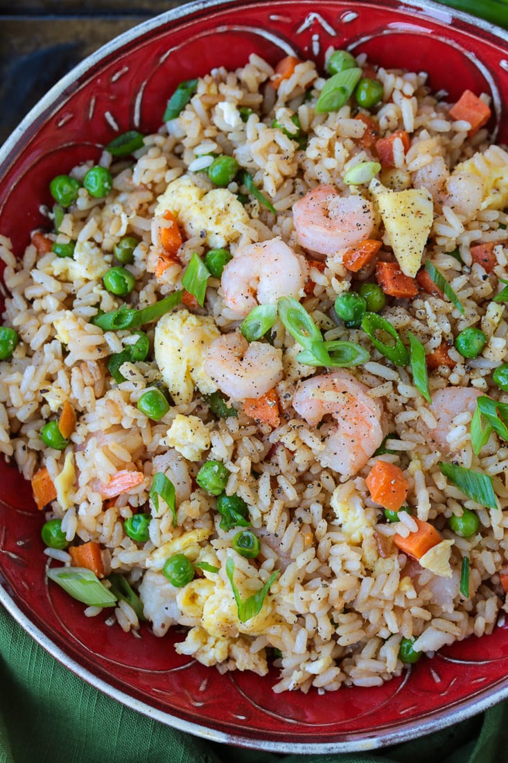 Shrimp Fried Rice is a classic Asian dish that's easy to make at home! A fun and healthy dinner that can be customized to your liking! shrimp fried rice in a red bowl from the top
