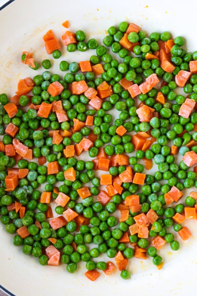 Shrimp Fried Rice is a classic Asian dish that's easy to make at home! A fun and healthy dinner that can be customized to your liking! peas and carrots in a skillet