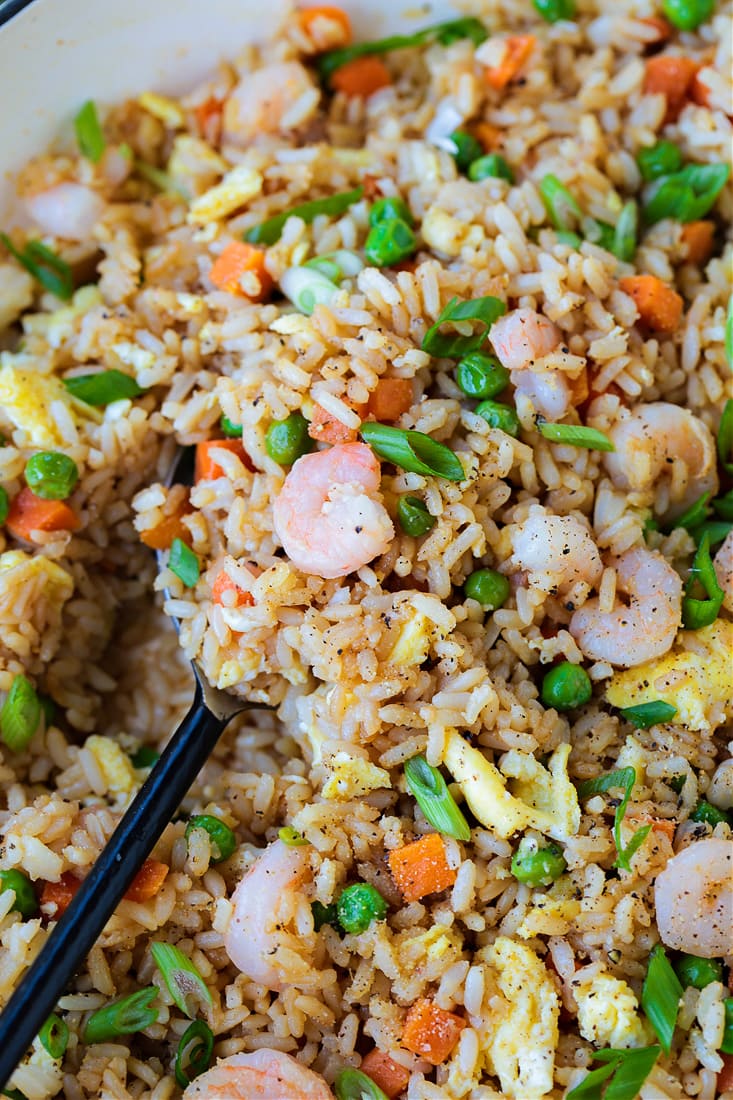 Shrimp Fried Rice is a classic Asian dish that's easy to make at home! A fun and healthy dinner that can be customized to your liking! shrimp fried rice in a skillet with spoon