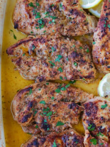 chicken breasts in a baking dish with Greek marinade