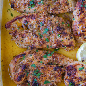 chicken breasts in a baking dish with Greek marinade