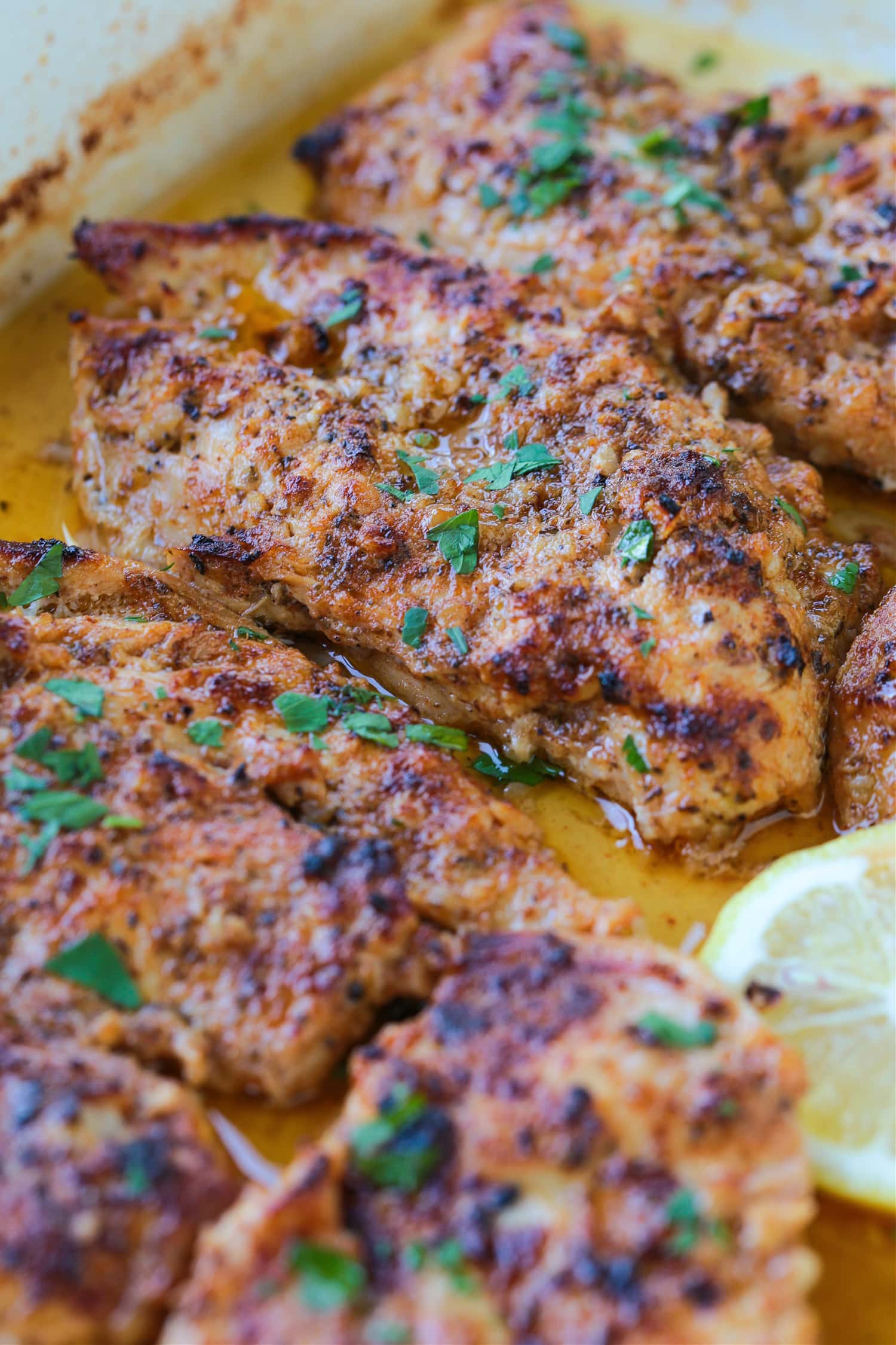 chicken breasts in a baking dish with greek marinade
