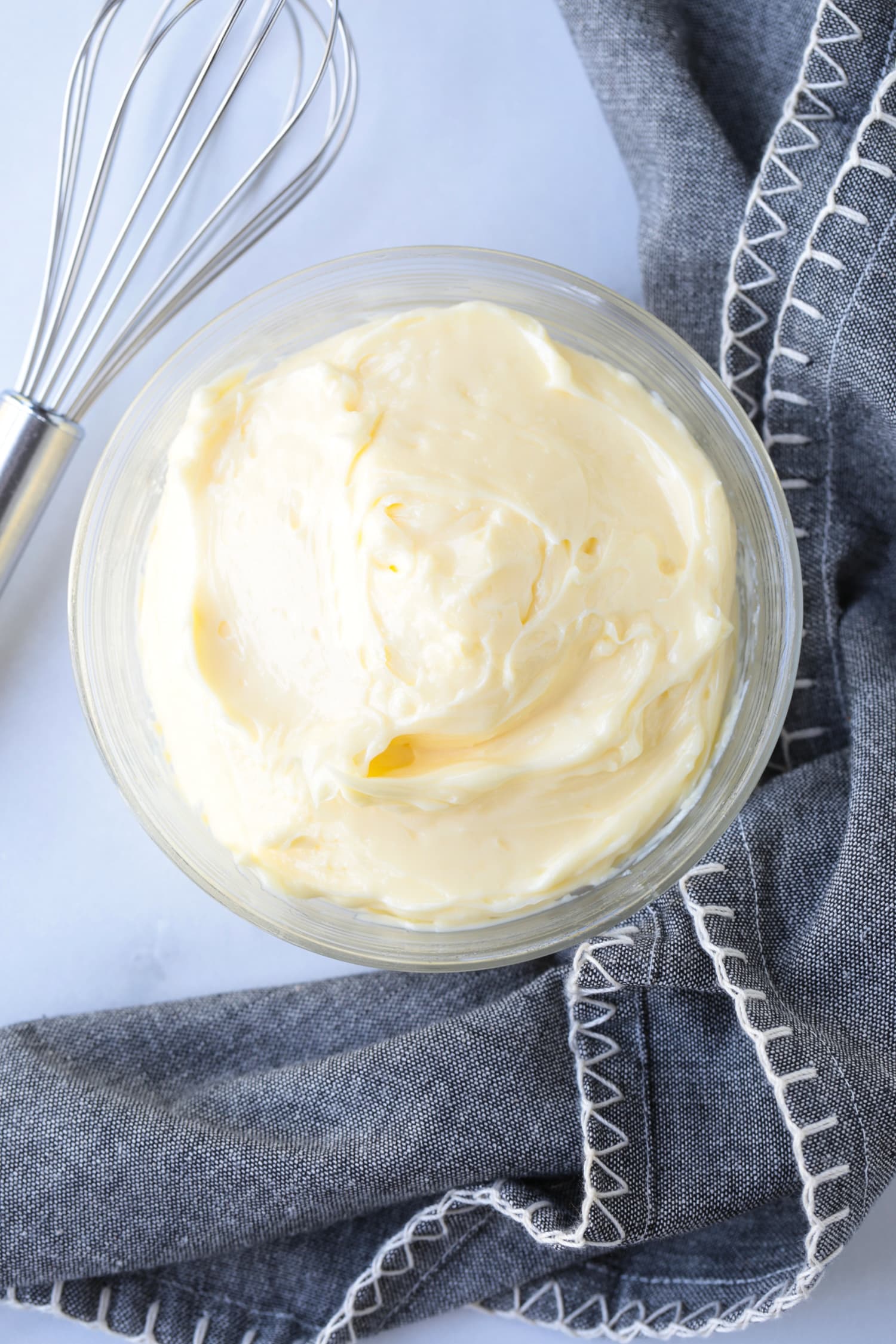 homemade mayonnaise is a dish with napkin and whisk
