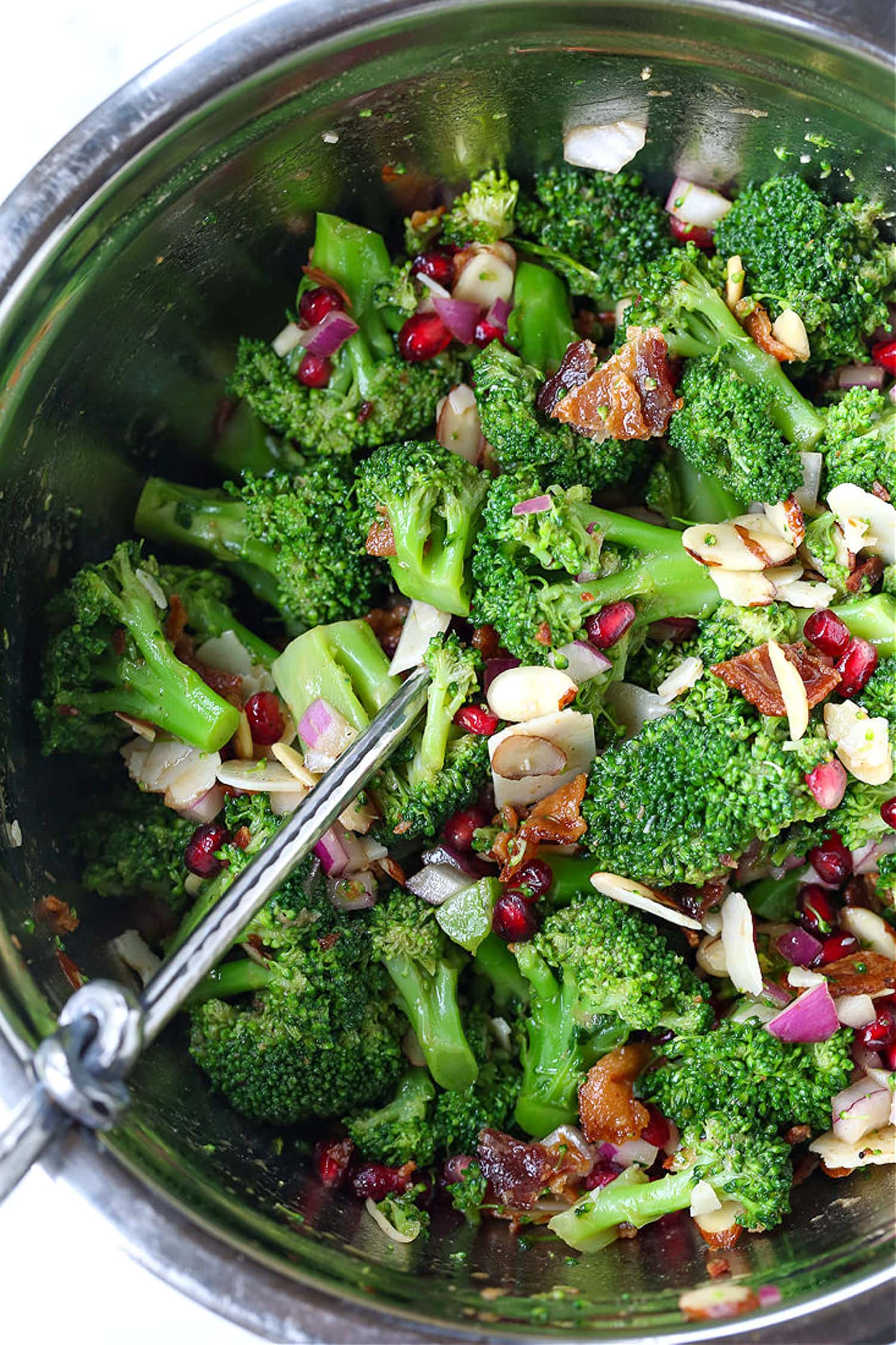 broccoli salad in silver bowl with spoon