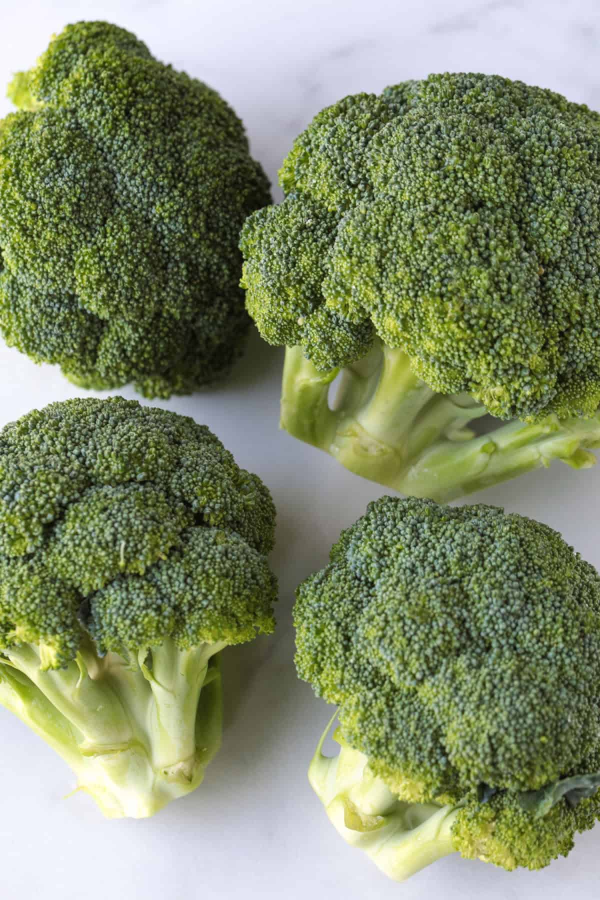 heads of broccoli on cutting board
