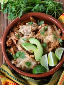 taco chicken in a bowl with cheese and avocado